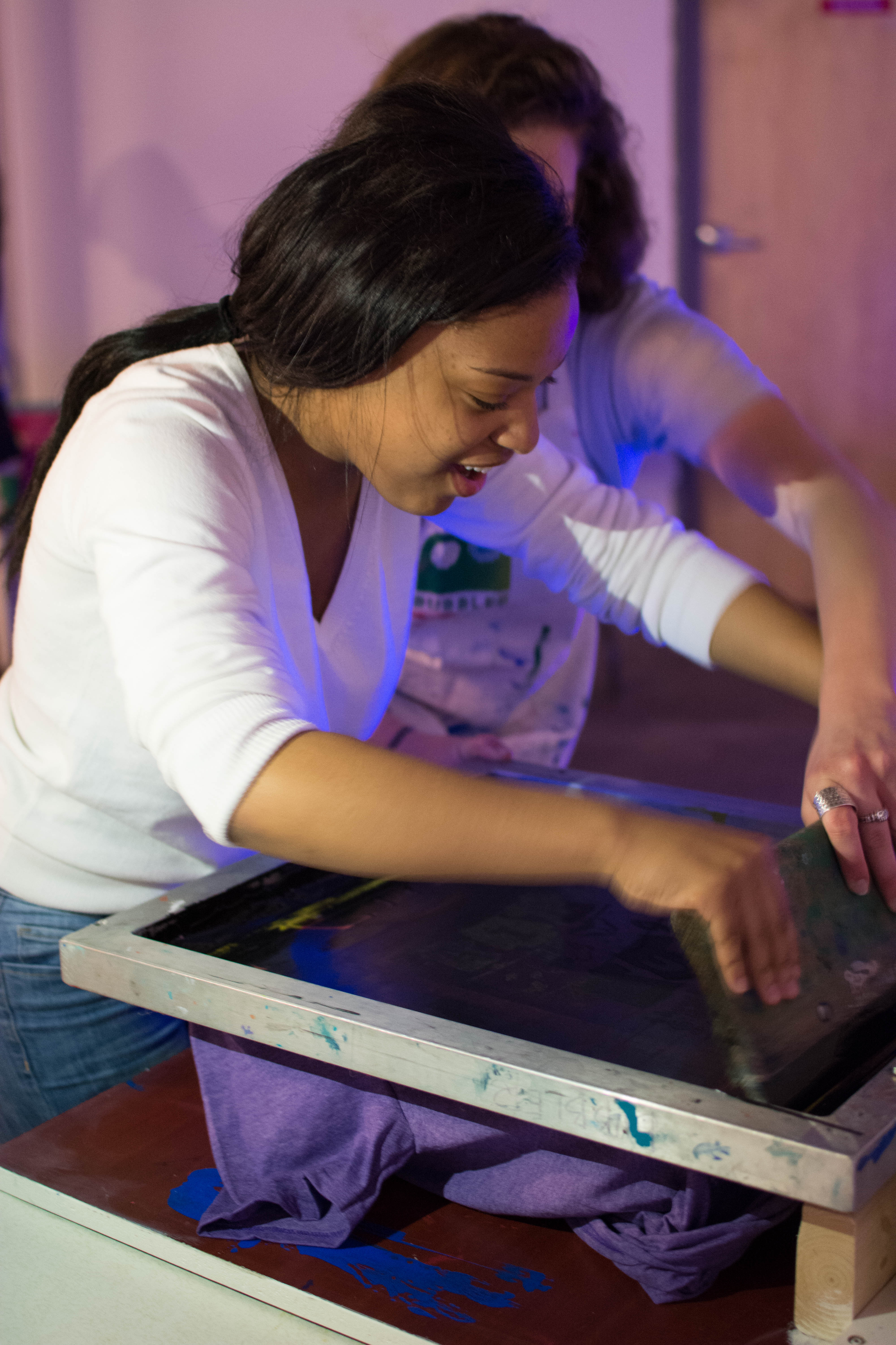 picture of teen screen printing at the Air It Out teen art exhibition party