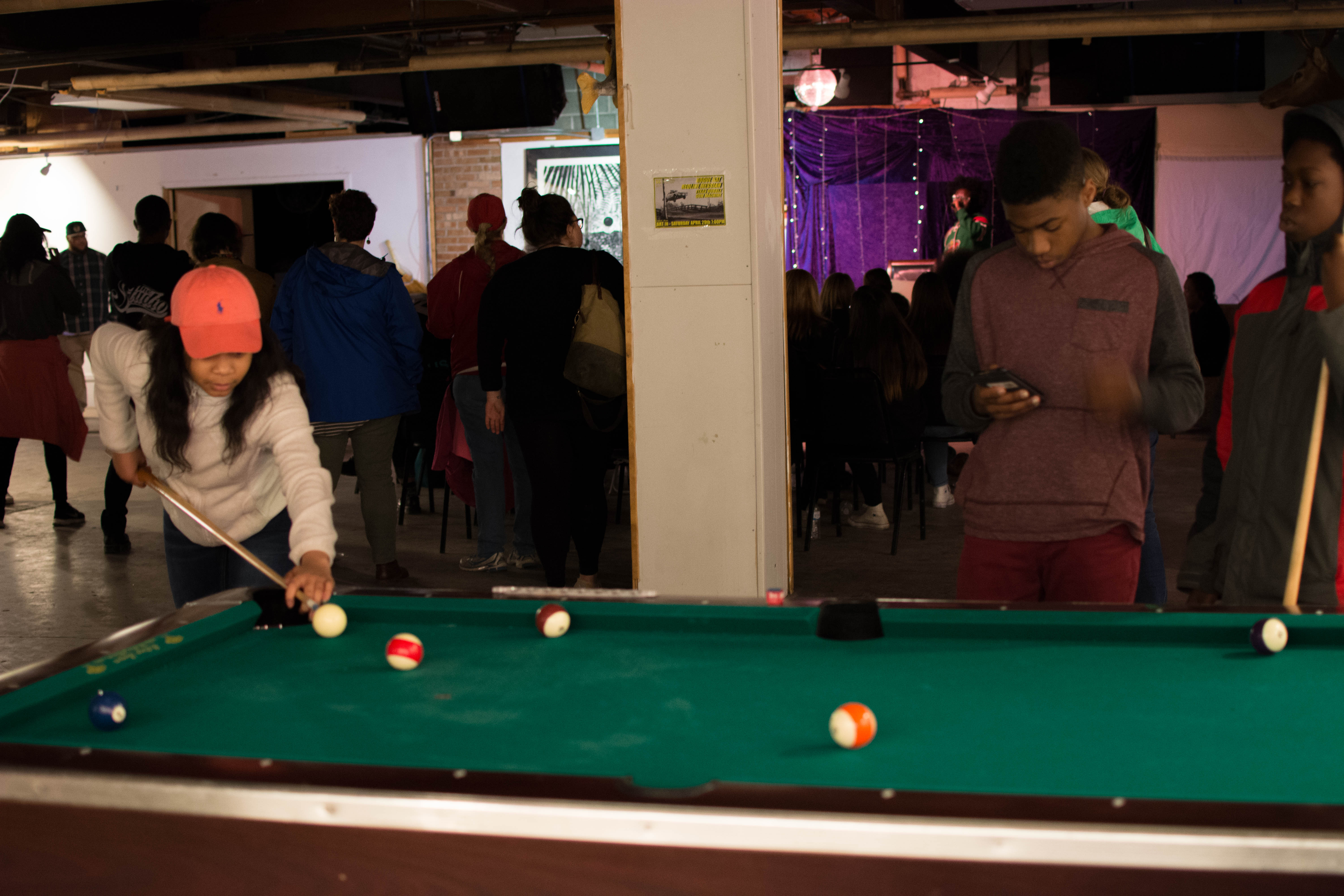 picture of teen playing pool at Air It Out teen art exhibition party