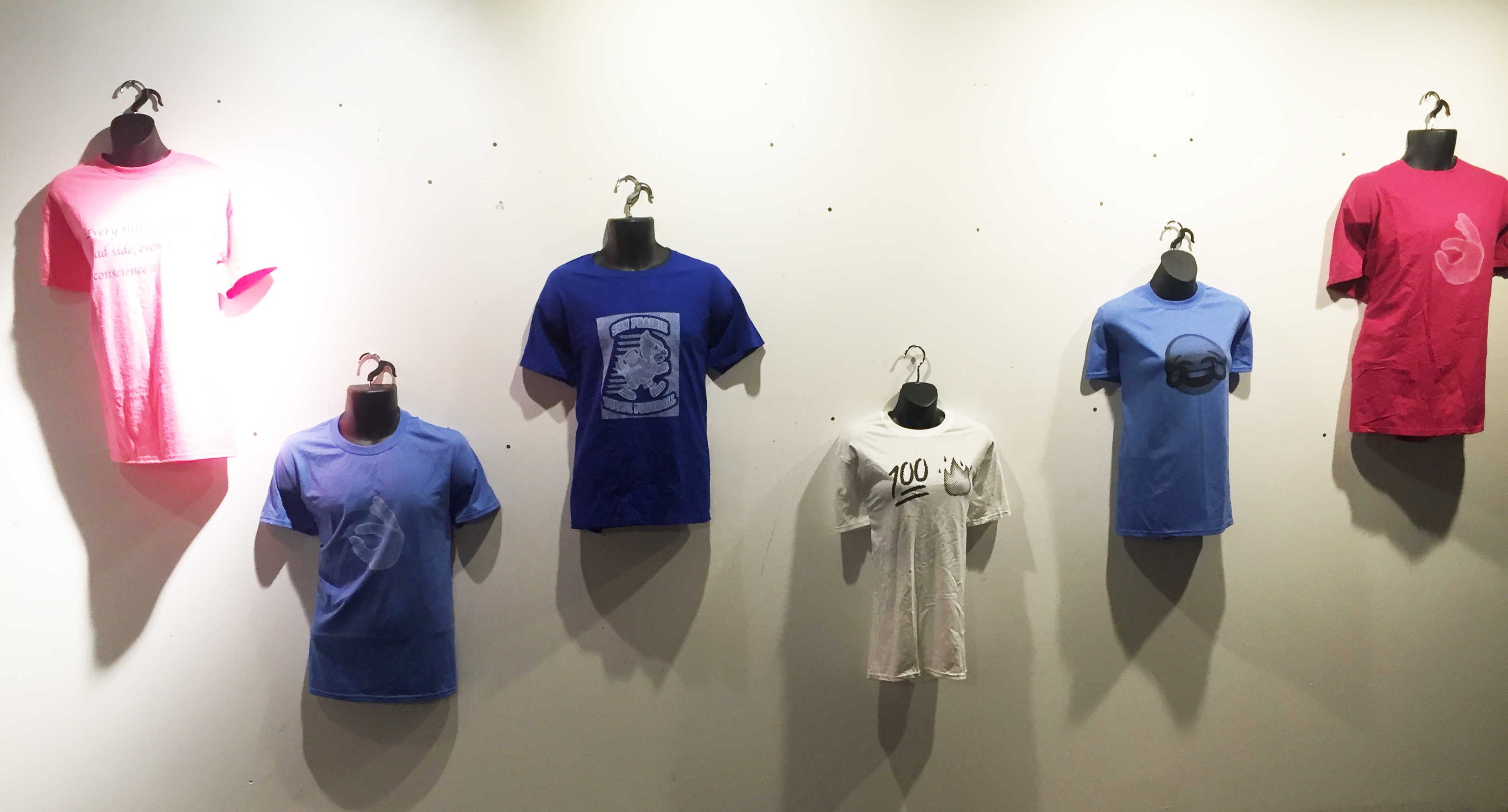 picture of screen printed shirts on display at Air It Out teen art exhibition