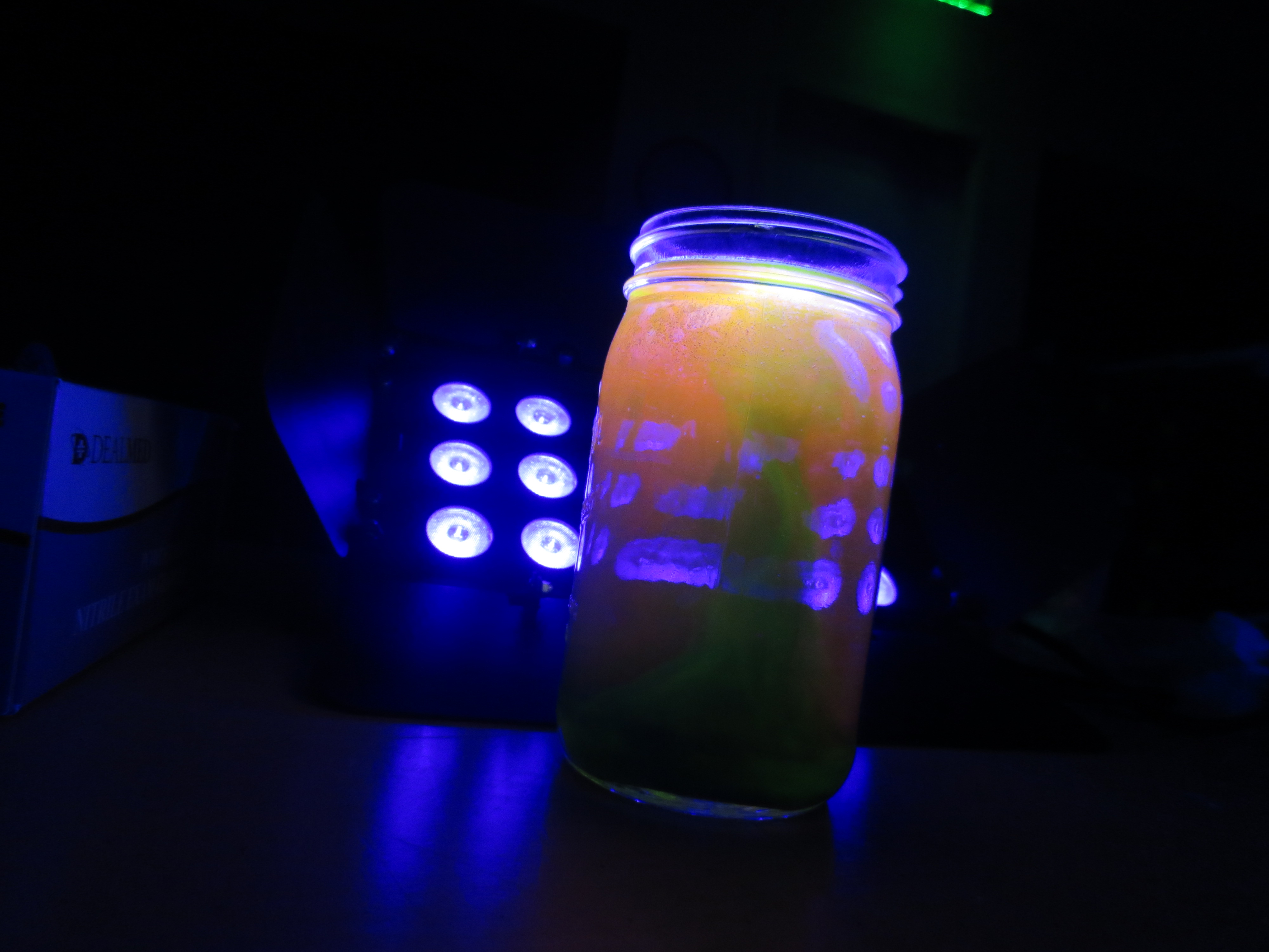 picture of black light reacting with jar of chemicals