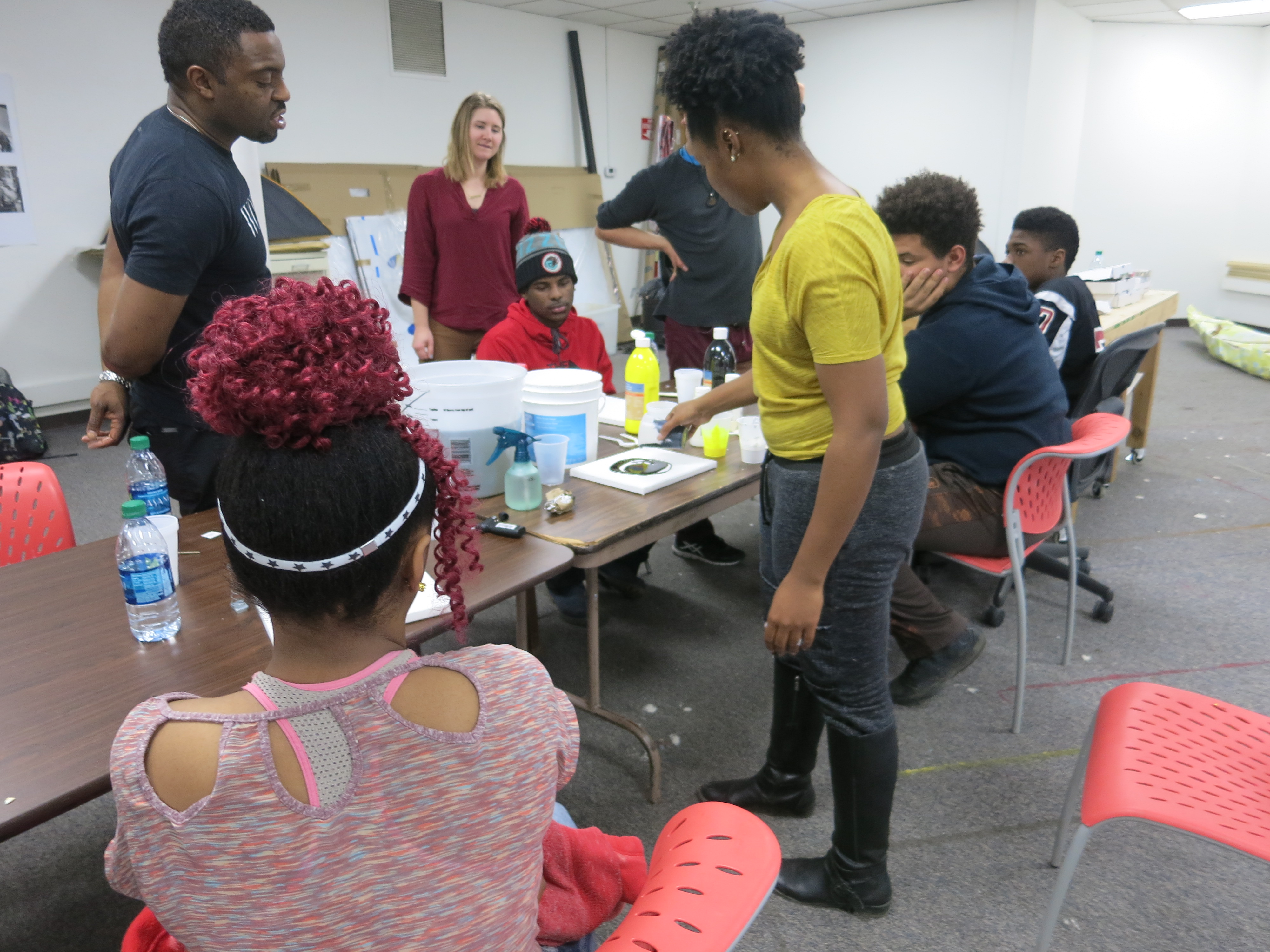 picture of teens creating drip paintings during Air It Out semester of art