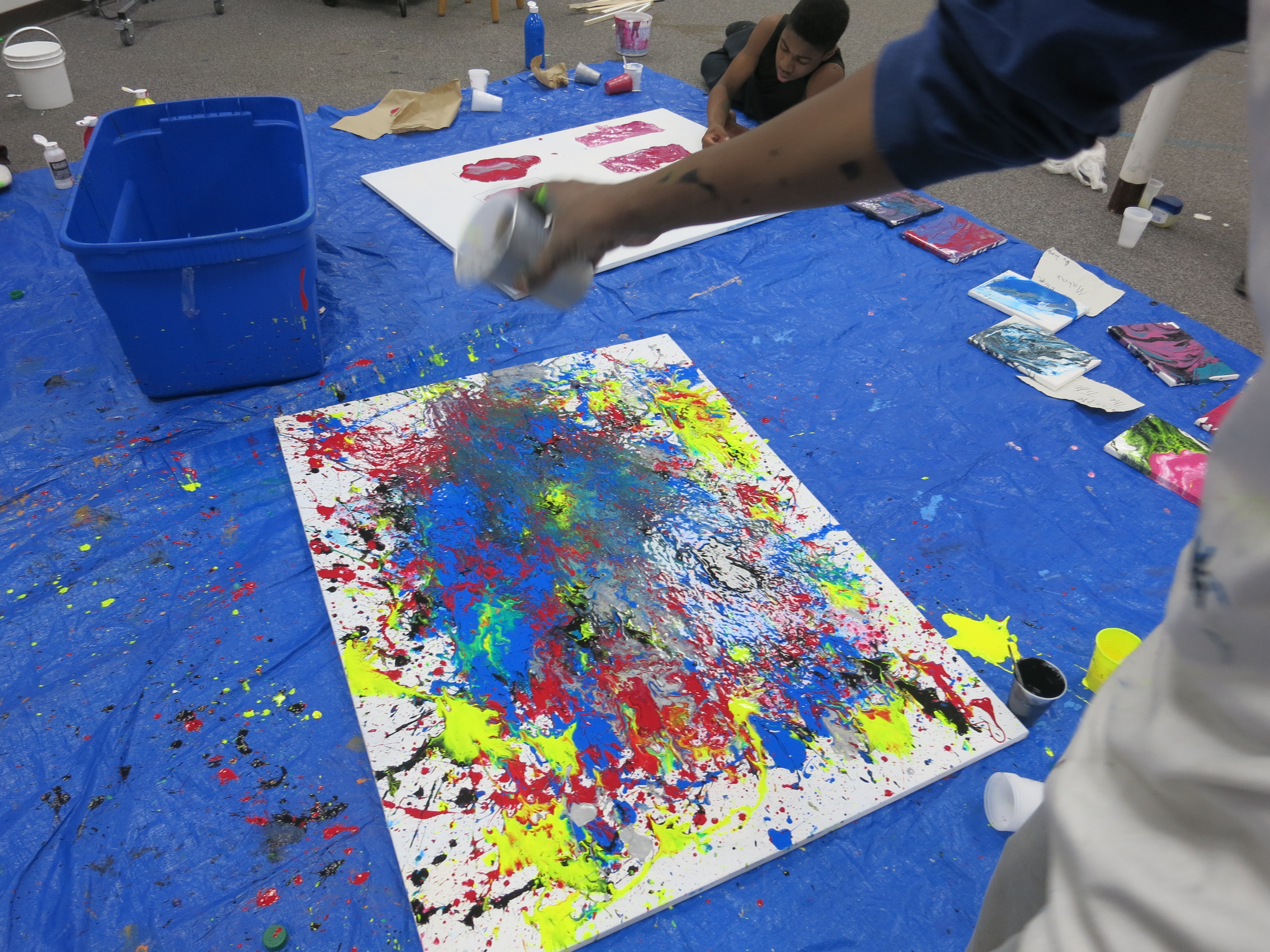 picture of teens creating drip paintings during Air It Out semester of art